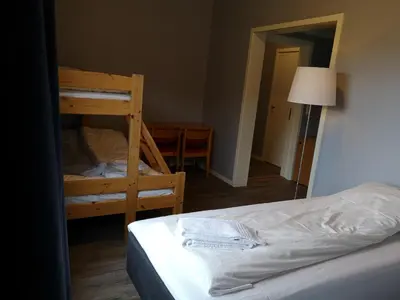 a bedroom with two bunk beds and a lamp at Dombåstun Motel in Dombås
