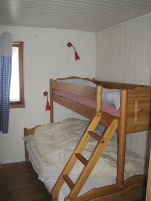 a bunk bed in a room with a ladder at Seljestad Cottages in Skare