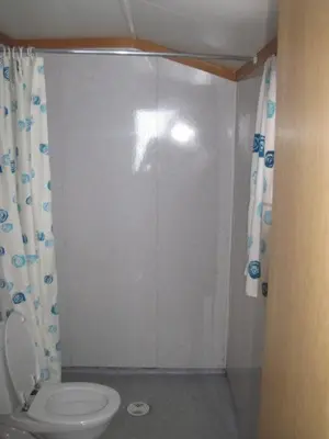 a bathroom with a toilet and a shower at Seljestad Cottages in Skare