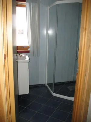 a bathroom with a shower and a sink at Seljestad Cottages in Skare