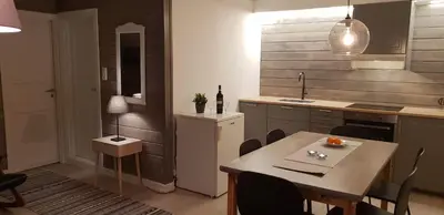 a kitchen with a table and a dining room at Oppdal Alpintun, Stølen øvre - ski in ski out in Oppdal