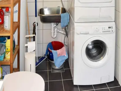 a laundry room with a washing machine and a washer at Seaside Serenity in Leirvik-By Traum in Bø