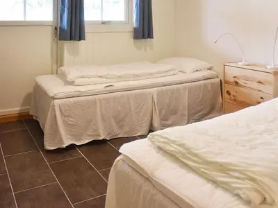 a room with two beds and a window at Seaside Serenity in Leirvik-By Traum in Bø