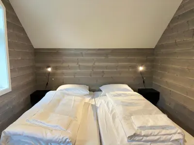 a bed in a room with two pillows on it at Brekke Gard Hostel in Flåm