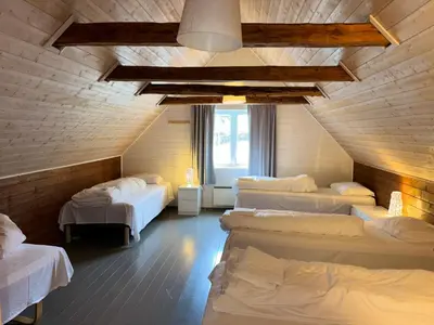 a room with a bunch of beds in it at Brekke Gard Hostel in Flåm