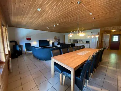 a dining room with a wooden table and chairs at Hafjell Grenda lejligheder og hytter in Hafjell