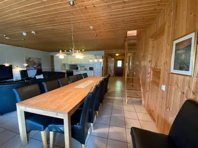 a dining room with a long wooden table and chairs at Hafjell Grenda lejligheder og hytter in Hafjell
