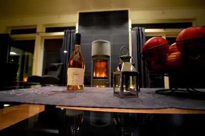 two bottles of wine sitting on a table with glasses at Otnes Sør - Luxury 140m2 in Aurland