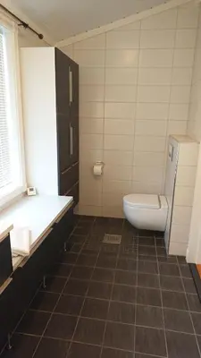 a bathroom with a toilet and a tub and a sink at Otnes Sør - Luxury 140m2 in Aurland