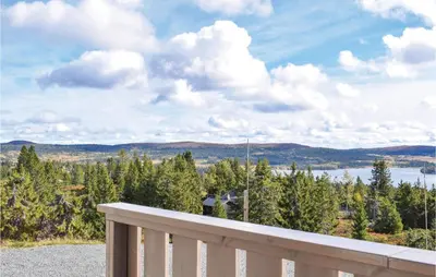 a balcony with a view of a lake and mountains at 3 Bedroom Stunning Home In Sjusjøen in Sjusjøen