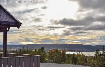 a house with a view of a lake and mountains at 3 Bedroom Stunning Home In Sjusjøen in Sjusjøen