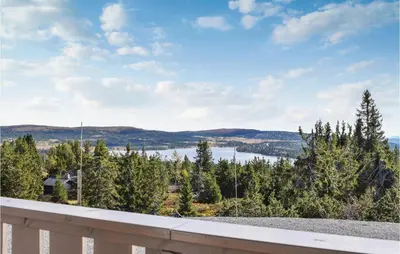 a view from the balcony of a house with trees at 3 Bedroom Stunning Home In Sjusjøen in Sjusjøen