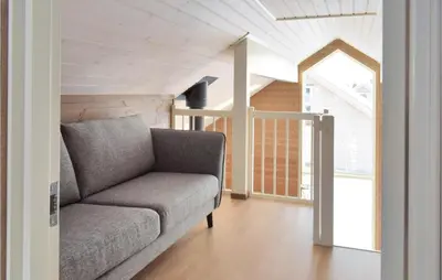 a living room with a couch and a window at 3 Bedroom Beautiful Home In Sjusjøen in Sjusjøen