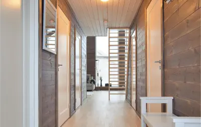 a hallway of a house with wooden walls at 3 Bedroom Beautiful Home In Sjusjøen in Sjusjøen