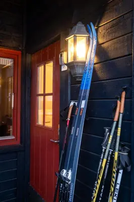 a group of skis on the side of a building at Supersentralt ski inn ski out in Geilo