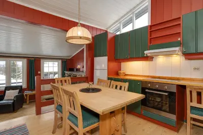 a kitchen with a wooden table and chairs at Bitigrenda B in Beitostøl