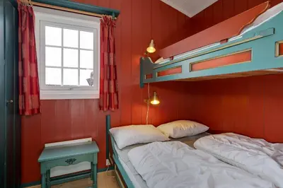 a bedroom with two bunk beds and a window at Bitigrenda B in Beitostøl
