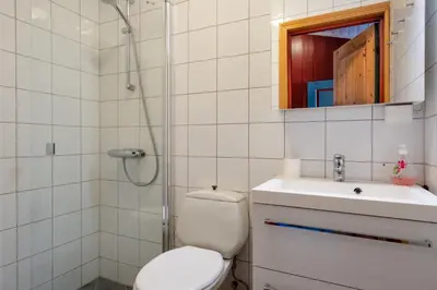 a bathroom with a toilet and a sink and a shower at Bitigrenda B in Beitostøl