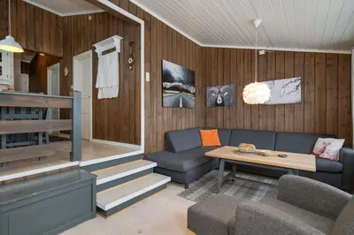 a living room with a couch and a table at Bitigrenda G in Beitostøl