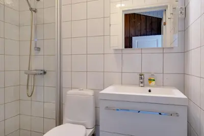a bathroom with a toilet and a sink and a shower at Bitigrenda G in Beitostøl
