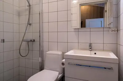 a bathroom with a toilet and a sink and a shower at Bitigrenda L in Beitostøl