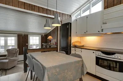a kitchen with a table and a dining room at Bitigrenda F in Beitostøl