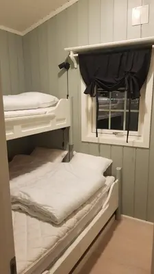 two bunk beds in a room with a window at Bitigrenda F in Beitostøl