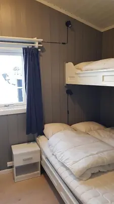 a bedroom with two bunk beds and a window at Bitigrenda F in Beitostøl