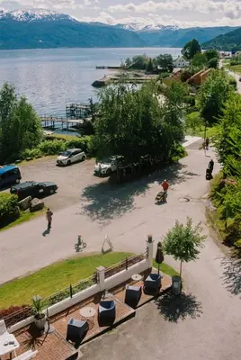 a view of a parking lot next to a body of water at Balestrand Hotel in Balestrand