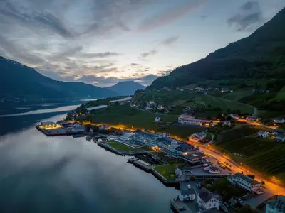 an aerial view of a town next to a river at Hotel Ullensvang in Lofthus