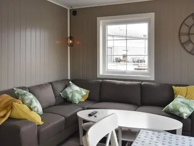 a living room with a couch and a table at 6 person holiday home in Oksvoll in Oksvoll