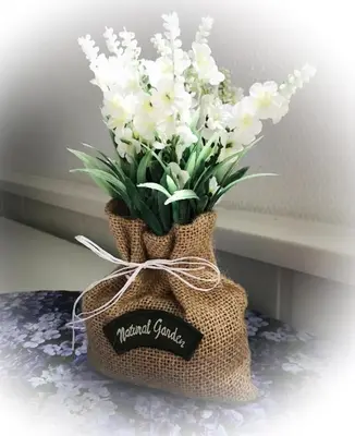 a bouquet of white flowers in a burlap bag at Apartment Dreamvalley in Isfjorden