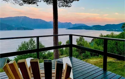 a deck with chairs and a view of the water at Gorgeous Home In Norheimsund With Wifi in Norheimsund