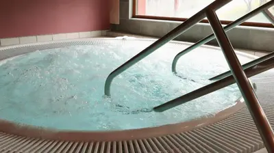 a jacuzzi tub in a bathroom with water at Unicare Røros in Røros