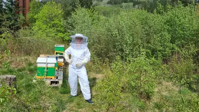 a man dressed in white standing in a field at Bergen Hostel Montana in Bergen