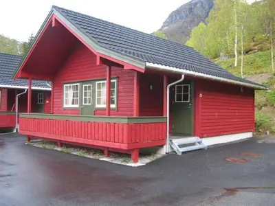 a red house with a black roof at Røldal Hyttegrend & Camping in Røldal