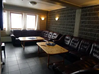 a waiting room with leather couches and a table at Jostedal Hotel in Jostedal