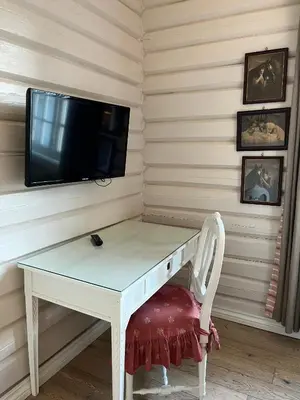 a white desk with a tv on a wall at Eggedal Borgerstue in Eggedal