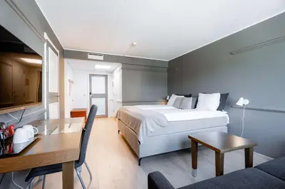 a hotel room with a bed and a table at Scandic Hønefoss in Hønefoss