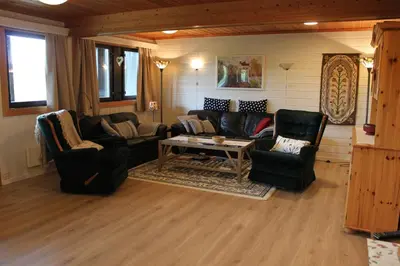 a living room with a couch and chairs and a table at Bergfosshytta in Ron