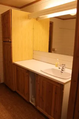 a bathroom with a sink and a mirror at Bergfosshytta in Ron