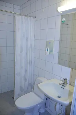 a white bathroom with a toilet and a sink at Rødungstøl Høyfjellshotell in Rødungstøl