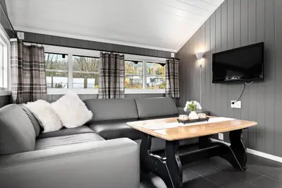 a living room with a couch and a table at First Camp Gol Hallingdal in Gol