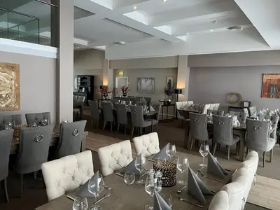 a restaurant with tables and chairs in a room at Geilo Superior leilighet in Geilo
