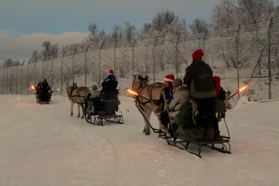 a group of people riding in a horse drawn sleigh at Langedrag Naturpark in Tunhovd