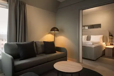 a living room with a couch and a bed at Scandic Victoria Lillehammer in Lillehammer