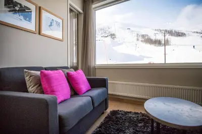 a living room with a couch and a large window at Myrkdalen Resort Hotel in Myrkdalen