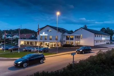 a group of cars parked in front of a building at Almaas Hotell Stord AS in Stord