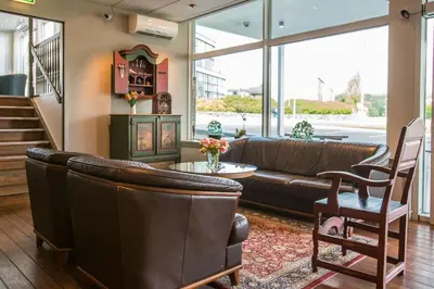 a living room with a couch and a table at Almaas Hotell Stord AS in Stord