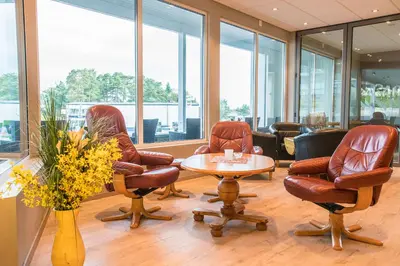 a meeting room with chairs and a table and a table and chairs at Almaas Hotell Stord AS in Stord